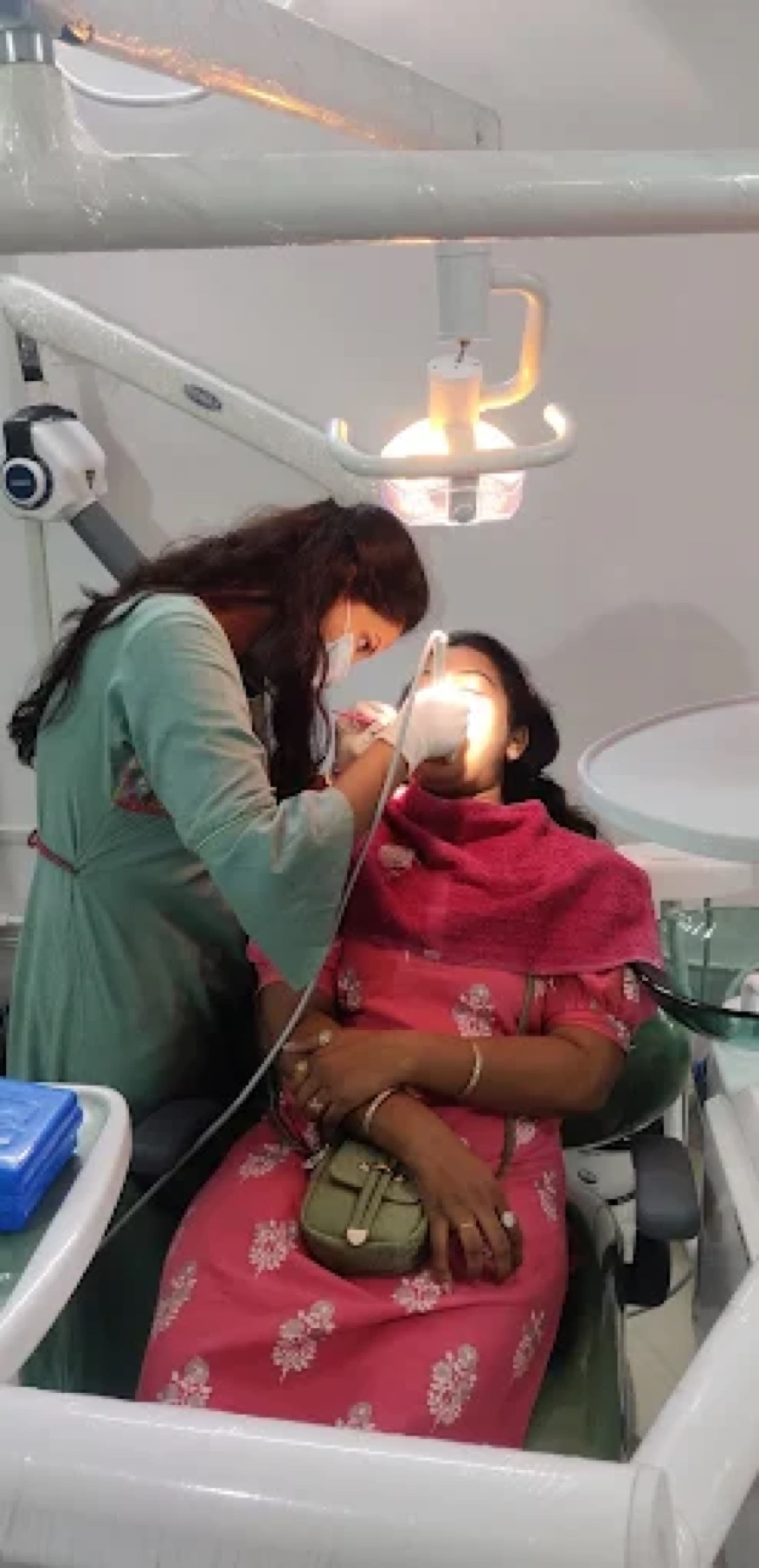 Dr. Ritu performing a chairside procedure at Nirvana Dental Care