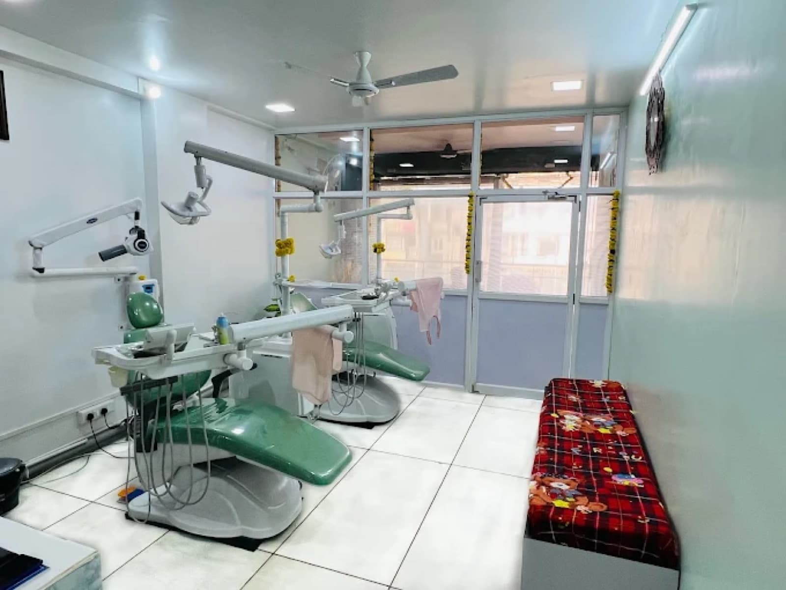 Treatment area with twin chairs, natural light, and clean tile flooring