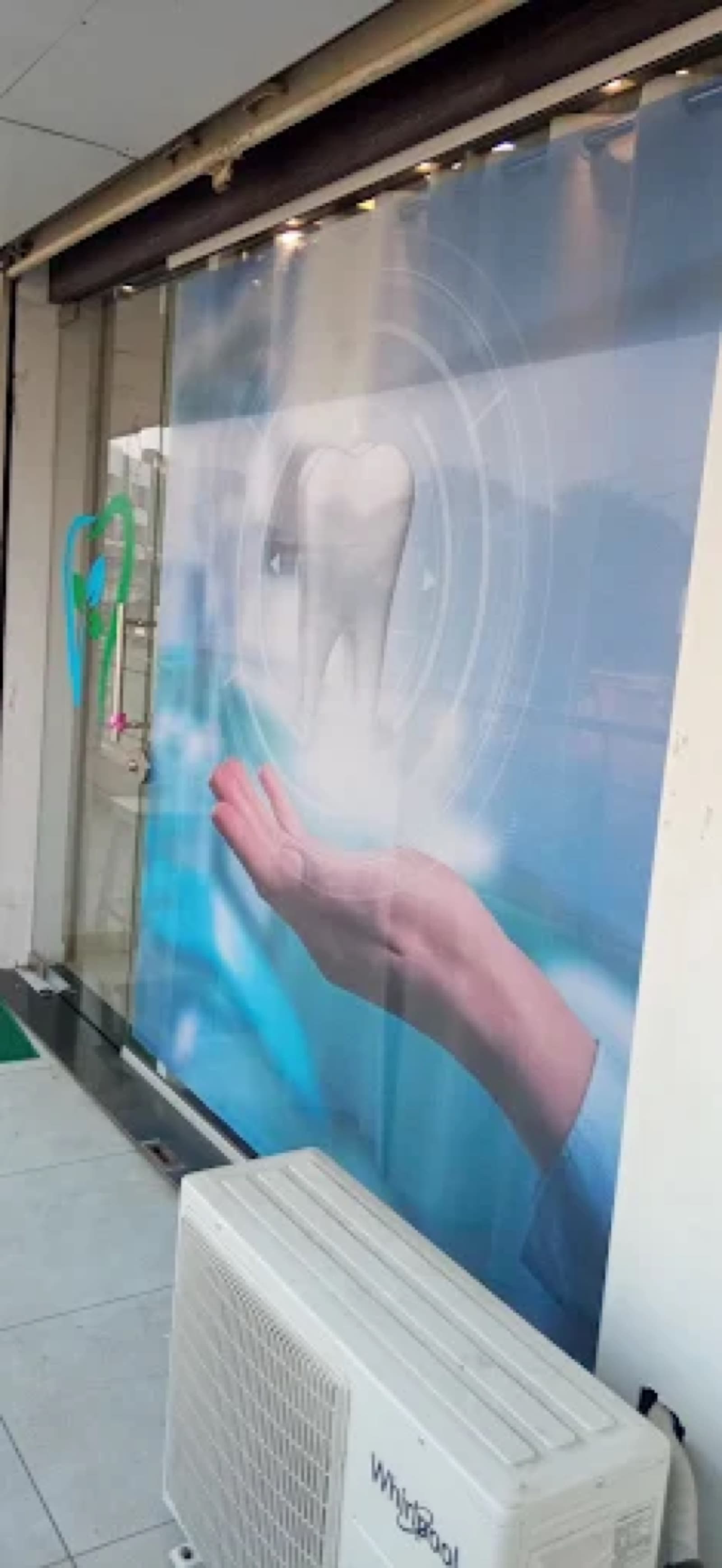 Tooth-themed banner welcoming patients at the clinic entrance